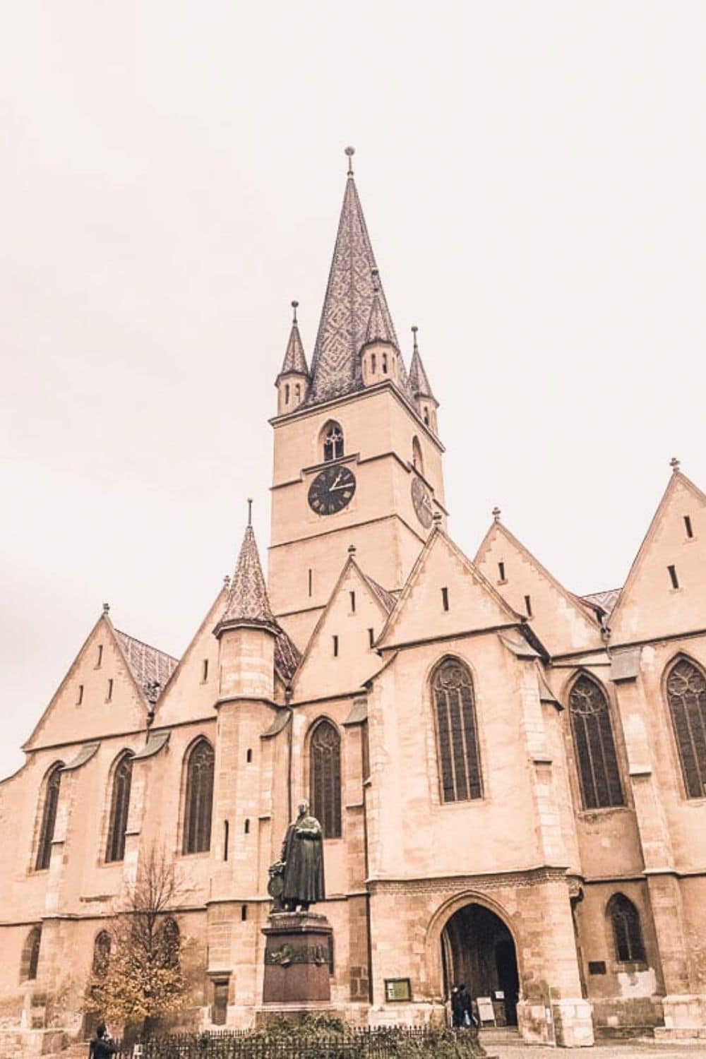 Stunning view of the Lutheran Cathedral of Saint Mary in Sibiu, showcasing its towering spire and intricate architecture, answering the query: Is Sibiu worth visiting?