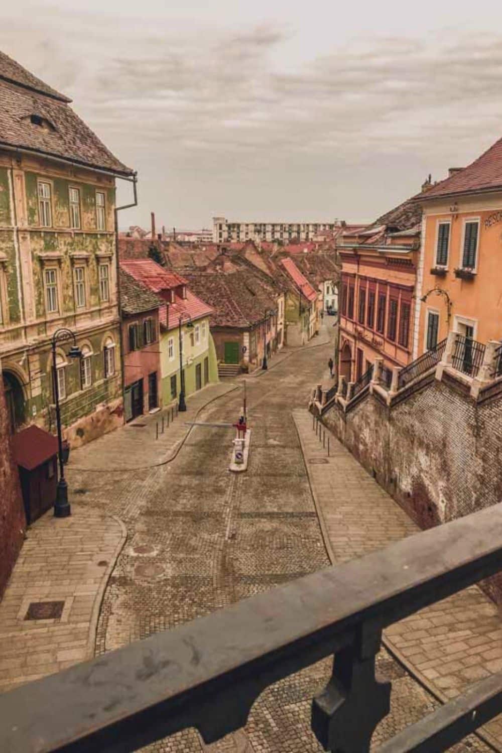 Elevated view of the charming streets of Sibiu's lower town, featuring traditional houses with colorful facades,