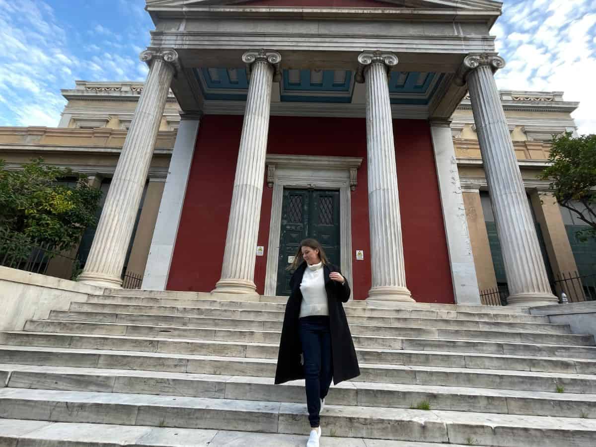 A woman in Athens in December coming down steps