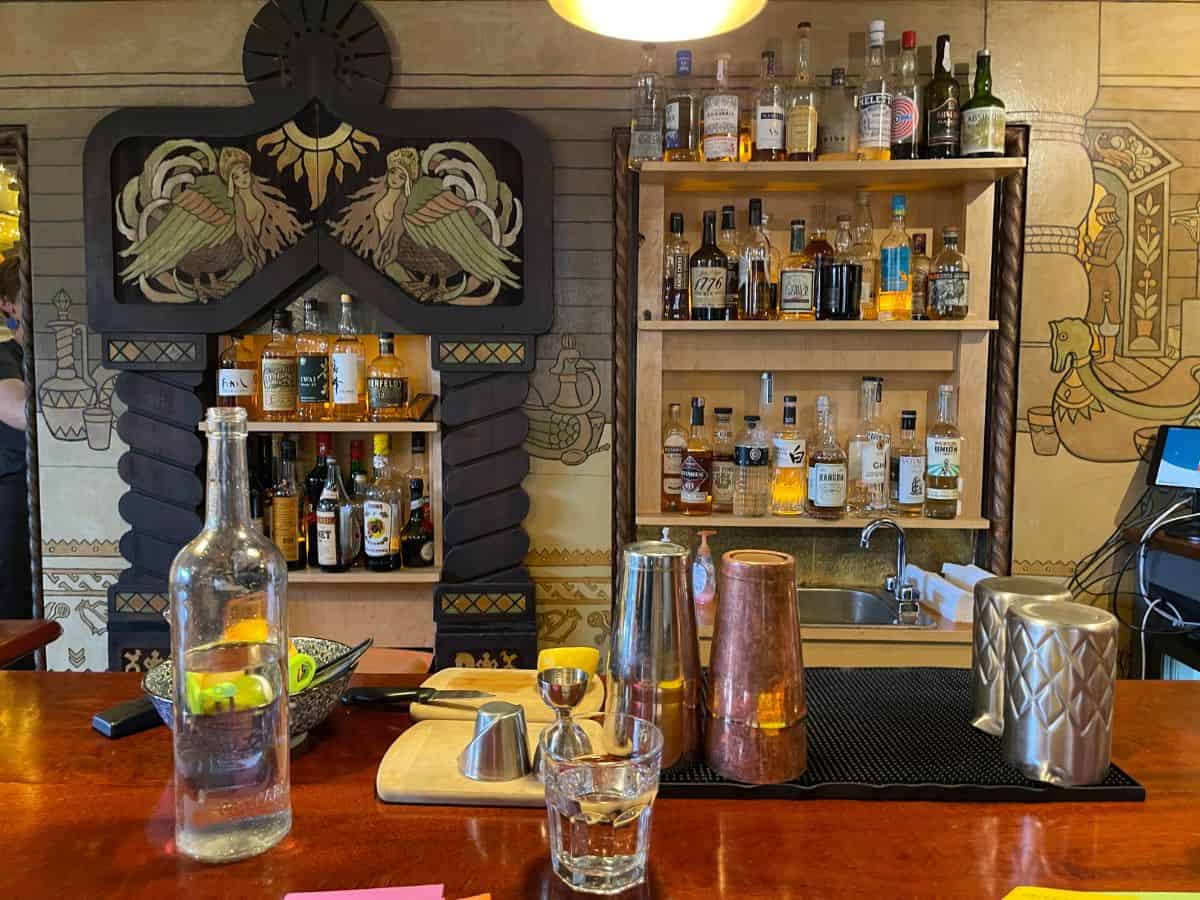 A bar with mixers and fruit and liquor