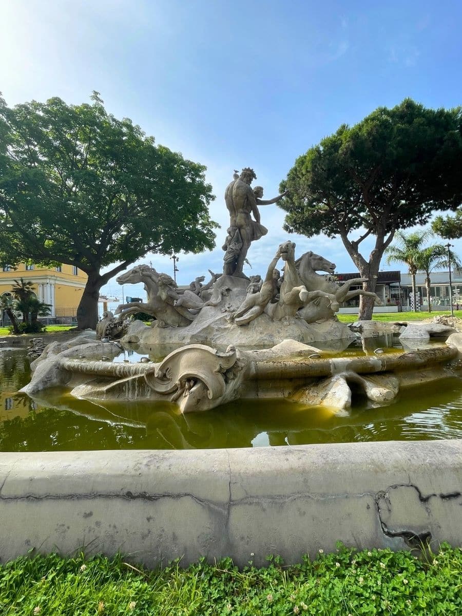 The Fountain of Proserpina (Fontana di Proserpina) in Catania, Sicily, featuring a statue of Proserpina being abducted by Pluto, surrounded by other figures and decorative elements.