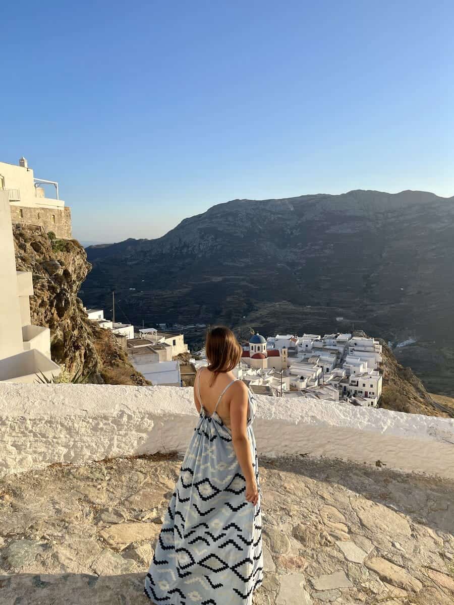 A solo woman in Serifos Greece looking at the town below.