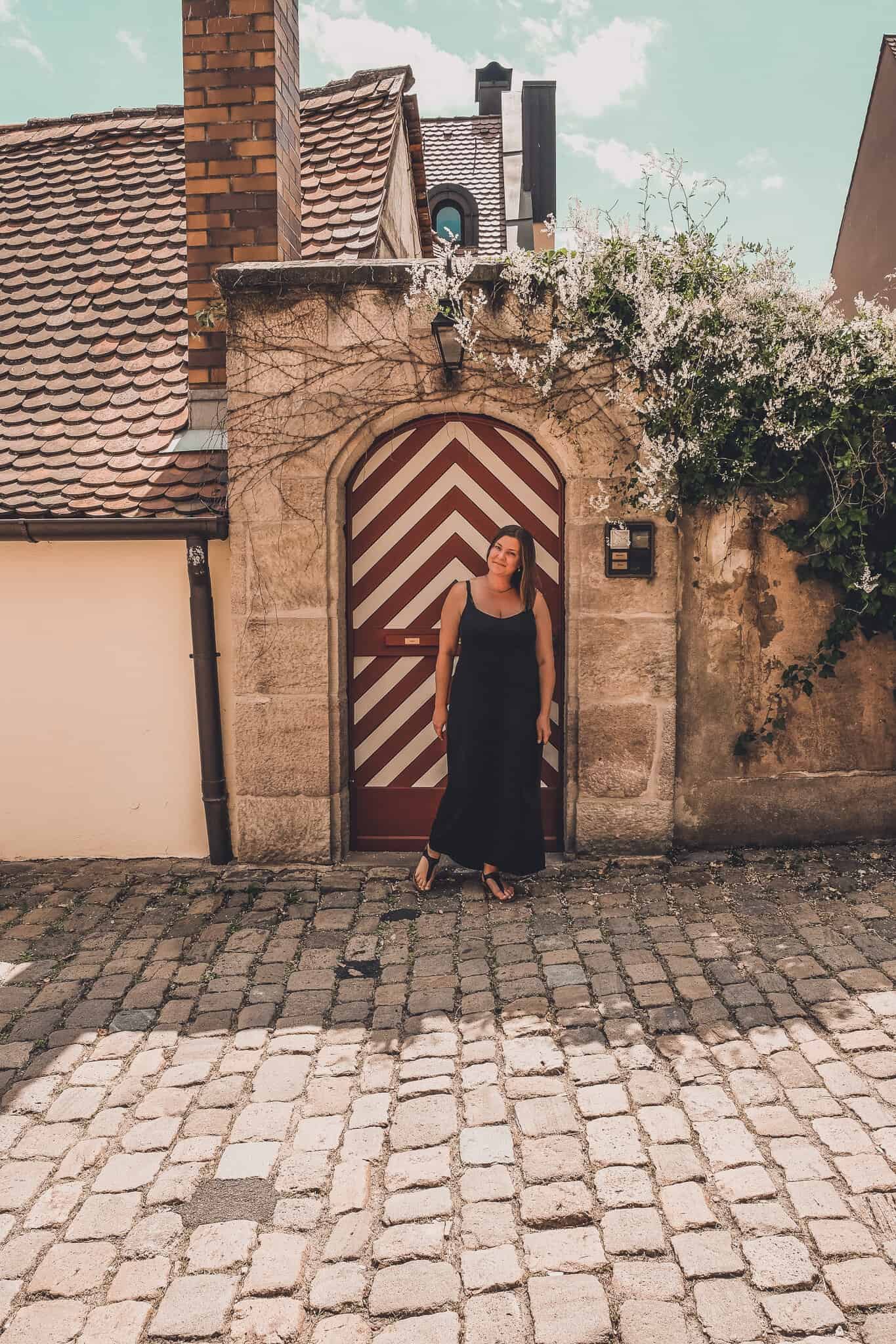 A woman in front of a striped doorway on the streets of Nuremberg