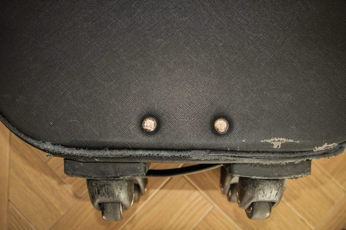 Suitcase wear and tear. View of the wheels on the bottom of the Smart Birdy suitcase.