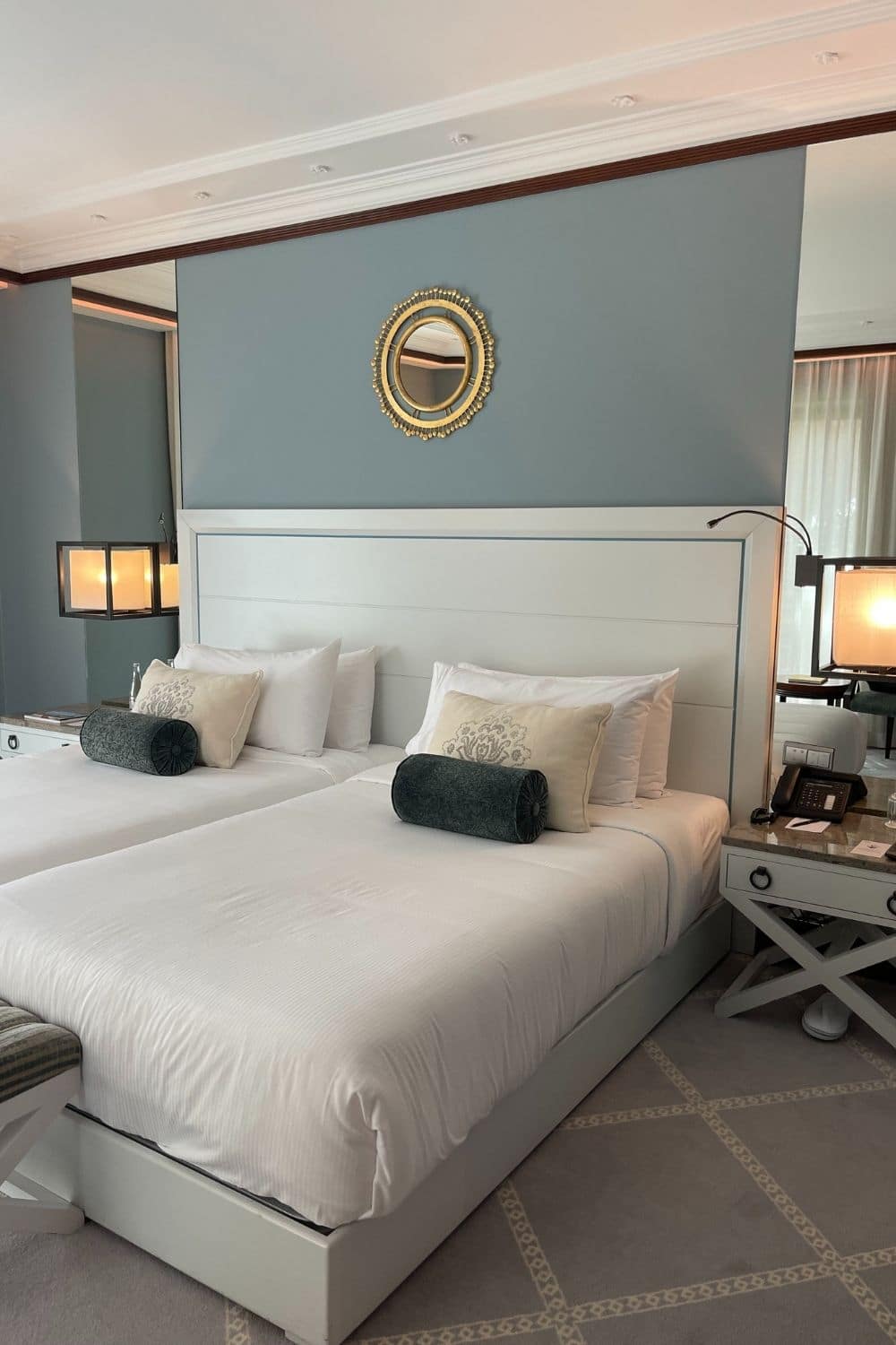 Elegant hotel room with a luxurious bed, sophisticated decor, and soft lighting, highlighting the comfort and style offered to travelers.