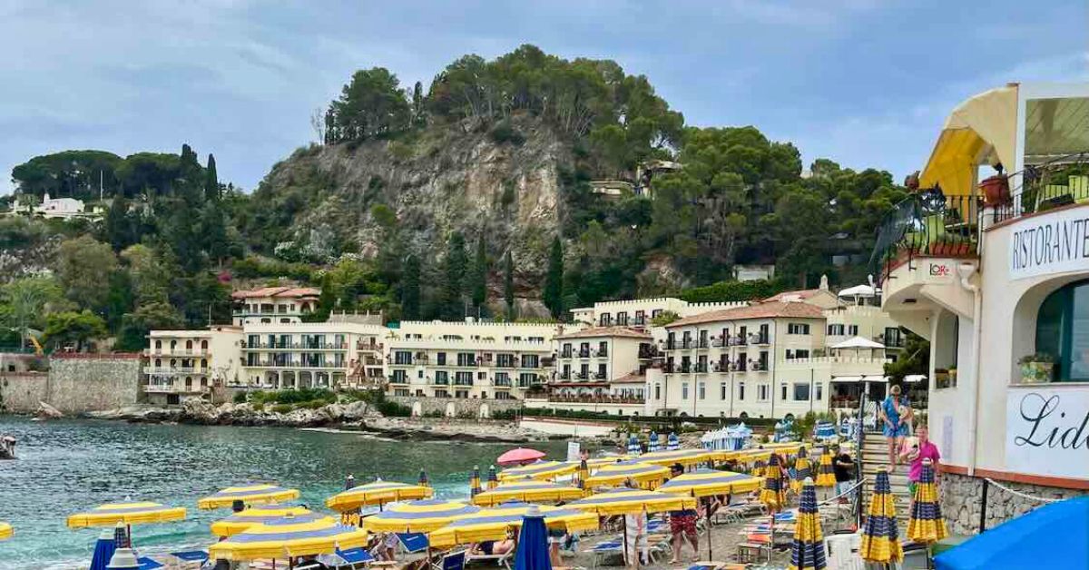 A view of the beach and expensive beach chairs in Taormina.