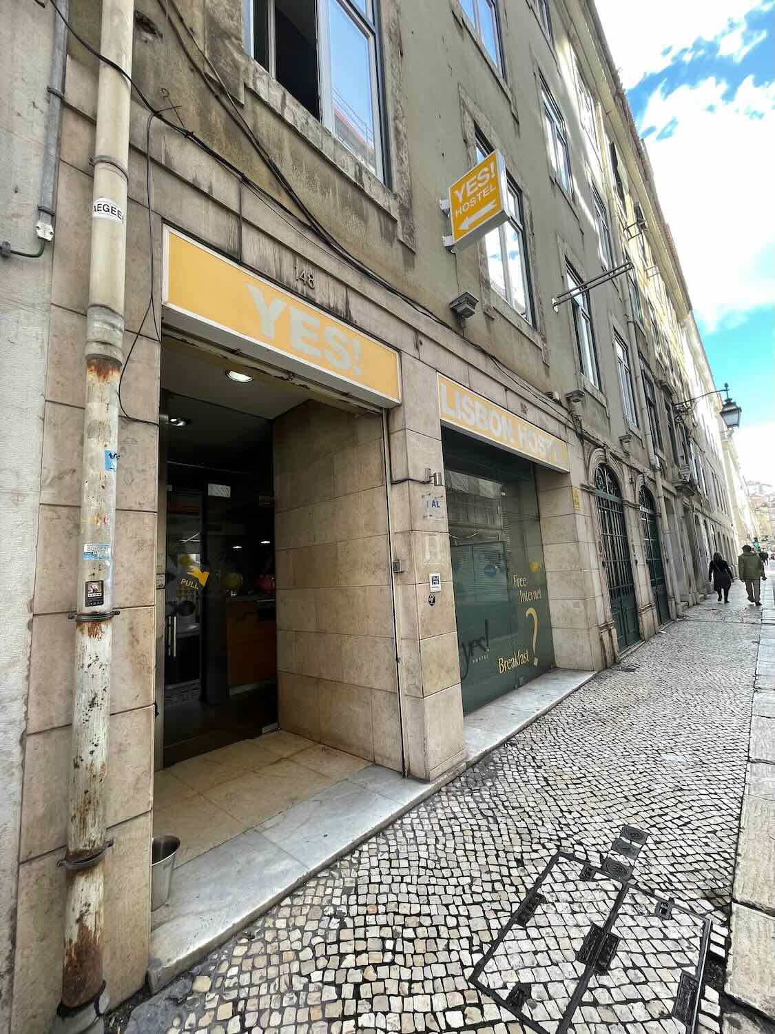 The entrance of 'YES! Lisbon Hostel', a modern traveler's accommodation in Lisbon, signaling a welcoming place to stay and socialize in the heart of the city.