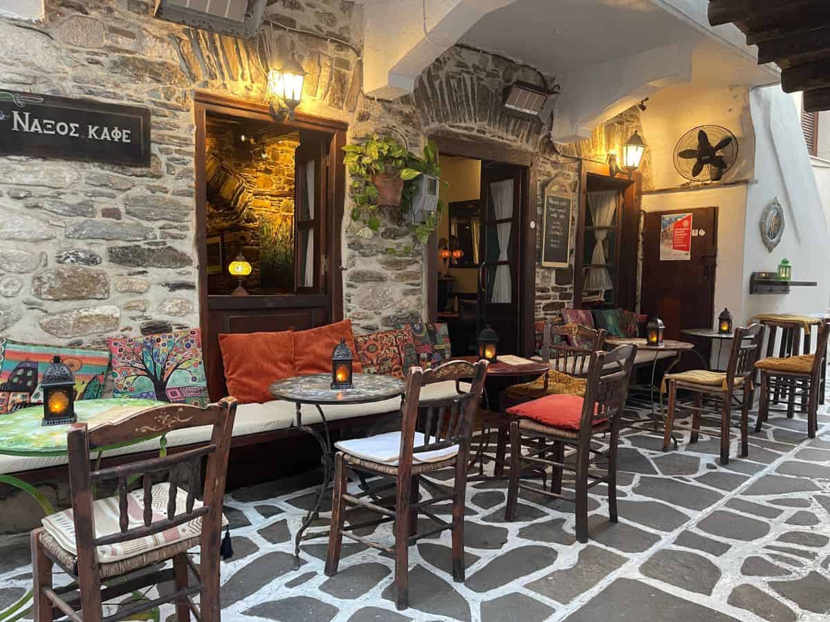 An empty bar with tables and chairs with little lanterns on top