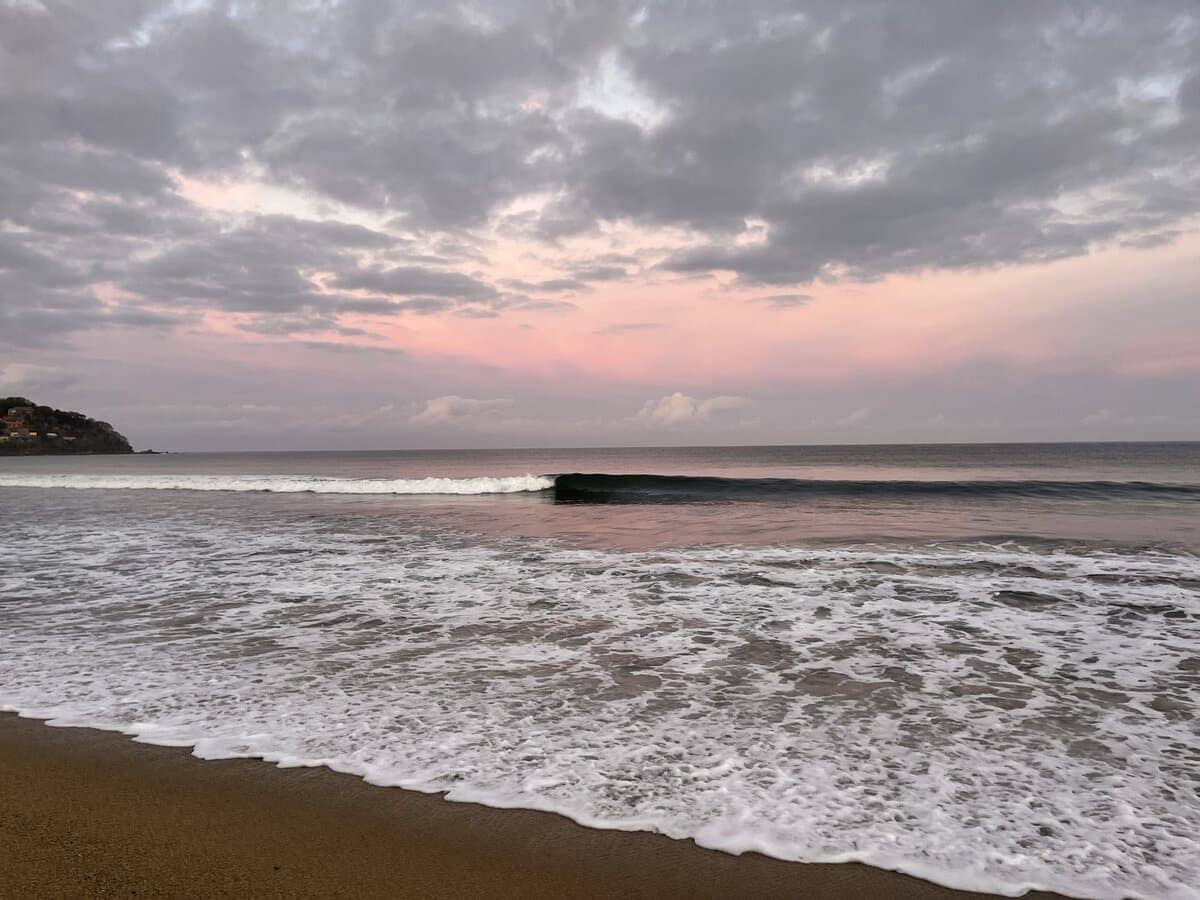 Sunrise in Sayulita with a pink sky and ocean waves