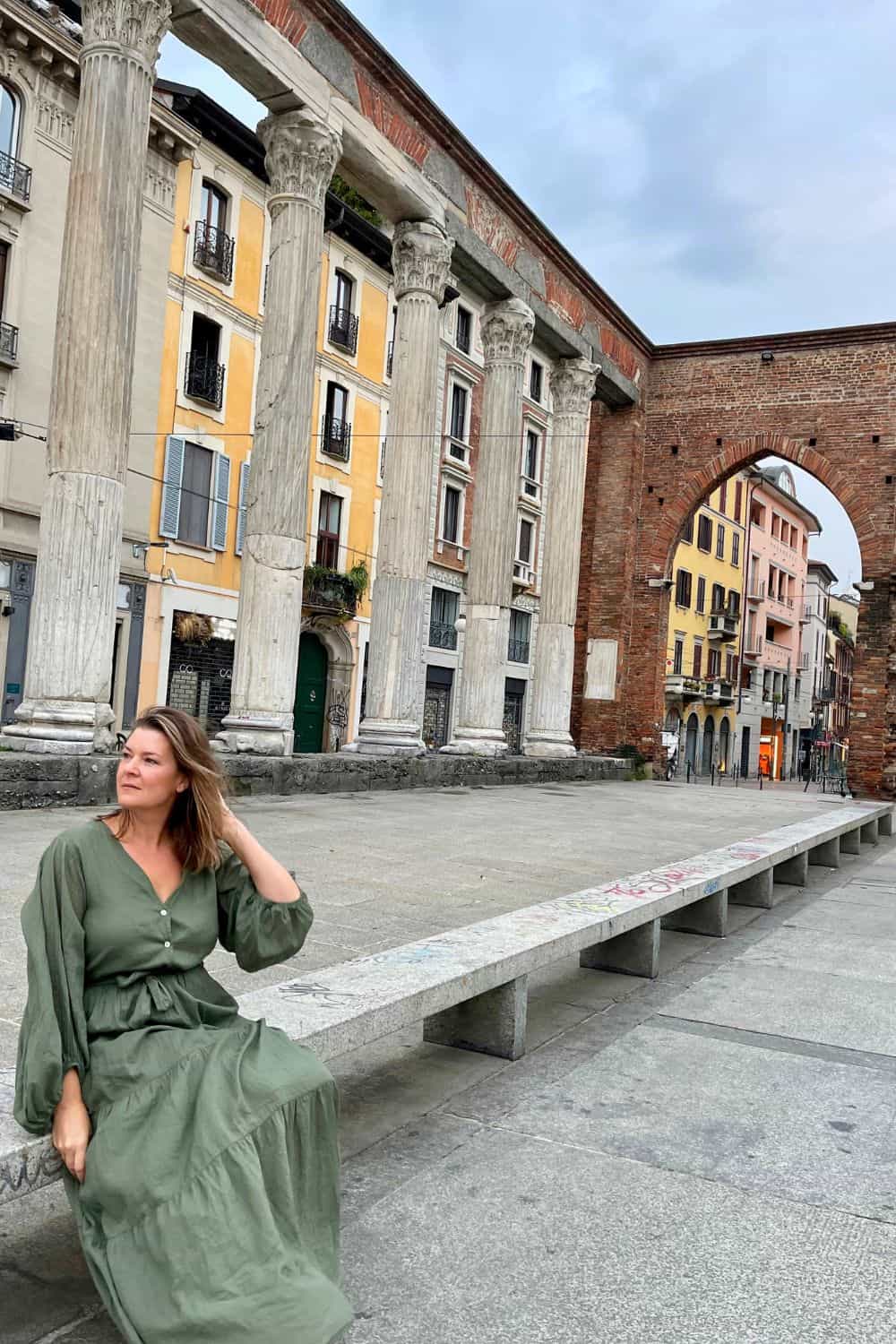 Woman sitting alone on a bench in Milan