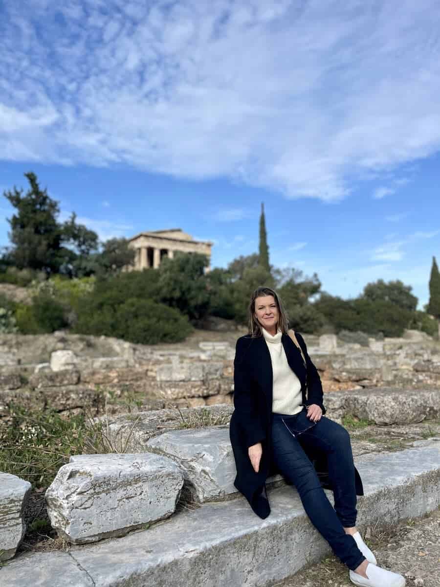A women in Athens Greece alone sitting on a stone bench