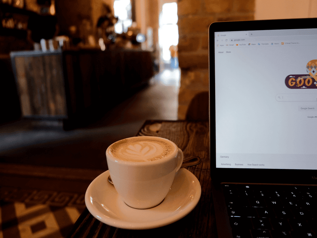 Coffee and laptop on a table at Distrikt Coffee, one of the best cafes to work in Berlin.