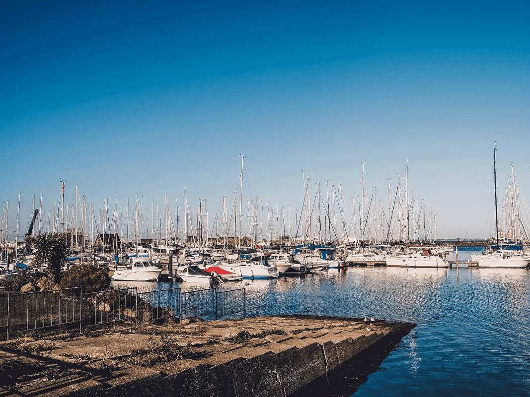 Clear day in Ireland with  a harbor full of boats